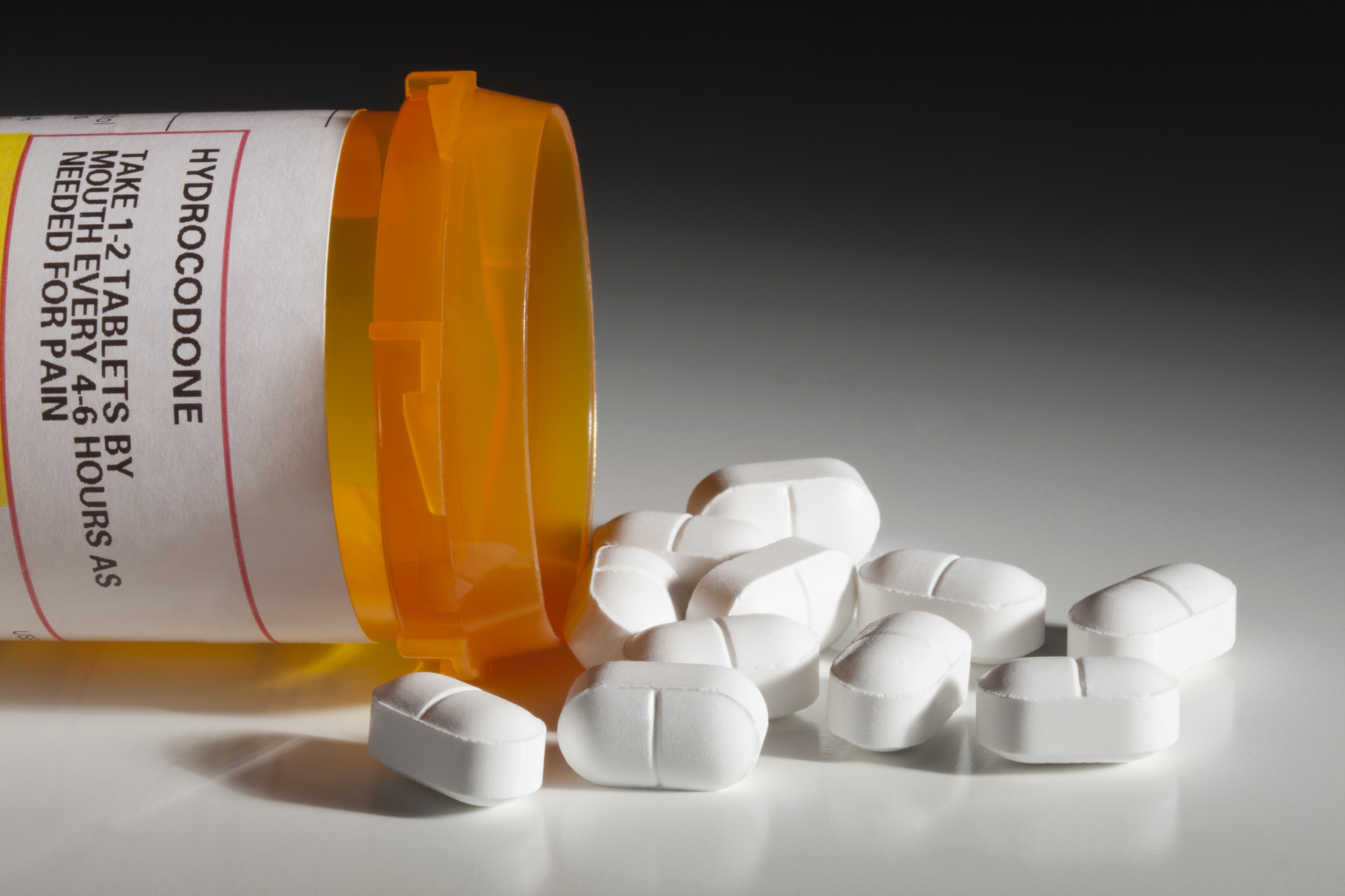 Pill bottle with spilled pills, photo by smartstock/Getty Images