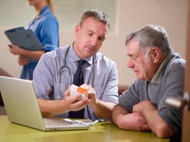 Doctor discussing a prescription with a patient, photo by sturti/Getty Images