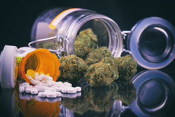 Cannabis buds and prescriptions pills, photo by rgbspace/Adobe Stock