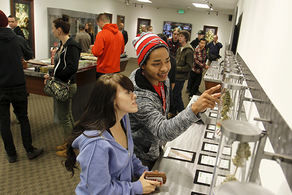 Young adults browse samples at Shango Cannabis on the first day of legal recreational marijuana sales in Portland, Oregon, October 1, 2015, photo by Steve Dipaola/Reuters