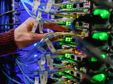 Data center technician performing server maintenance, photo by Tatyana Aksenova/Adobe Stock