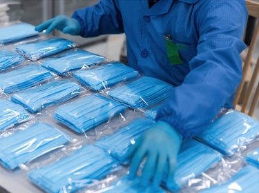 Medical mask production workers are organizing masks, photo by InkheartX/Adobe Stock