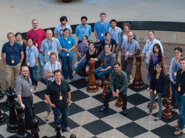 Students from the Frederick S. Pardee RAND Graduate School gather on the chess set outside of the RAND offices in Santa Monica, CA