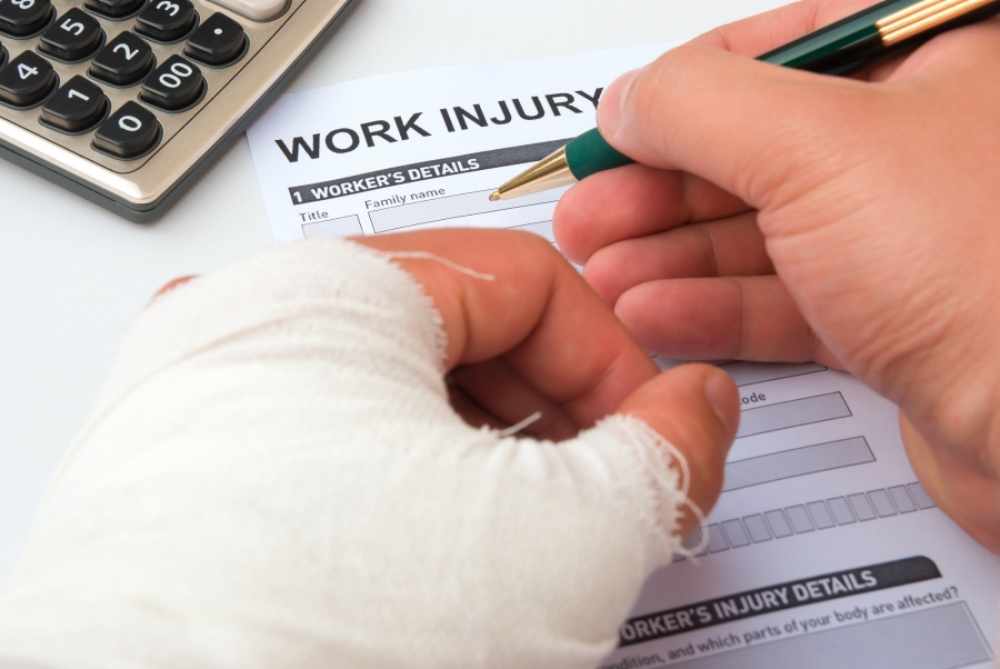 Person filling out a work injury claims form