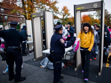 Runners pass through scanners as they are checked by New York Police Department officers upon arrival for the New York City Marathon, November 3, 2013