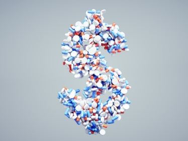 Pills formed into the shape of a dollar sign, photo by Petmal/Getty Images