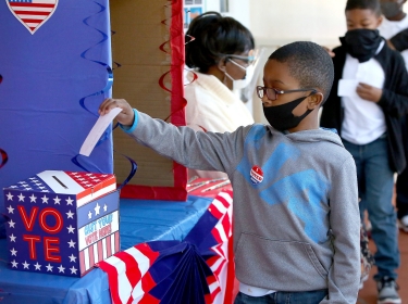 A second grade student votes during a mock election at his school in Gainesville Florida, Nov. 3, 2020, photo by Brad McClenny/Reuters