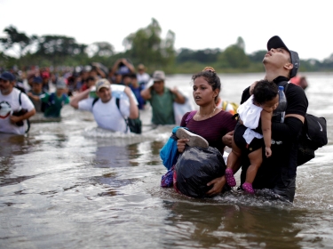 Daniel holds 1-year-old Daniela, both from El Salvador, as a group of migrants from Central America en route to the United States crossed through the Suchiate River into Mexico, November 2, 2018