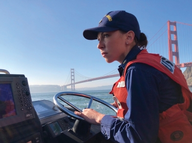 Petty Officer 1st Class Krystyna Duffy, a boatswain's mate assigned to Coast Guard Station Golden Gate in San Francisco, drives a 47-foot Motor Lifeboat near the Golden Gate Bridge, February 8, 2018, photo by PO3 Sarah Wi/U.S. Coast Guard