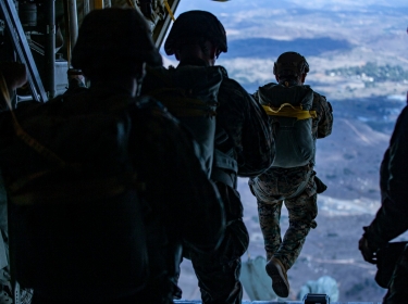 U.S Marines static line jump from a KC-130J Hercules over Drop Zone Basilone on Marine Corps Base Camp Pendleton, Calif., December 10, 2020, photo by Lance Cpl. Drake Nickels/U.S. Marine Corps