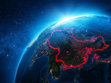 China outlined in red on a NASA image of Earth, photo by NASA and RomoloTavani/Getty Images