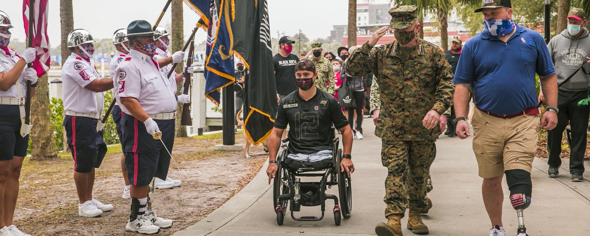U.S. Marine Corps Gen. Kenneth F. McKenzie, Jr., the commander of U.S. Central Command, center right, salutes the Wounded Warrior Football Team Color Guard during a Wounded Warrior Amputee Dog Stroll in Tampa, Fl., Feb. 6, 2021. 