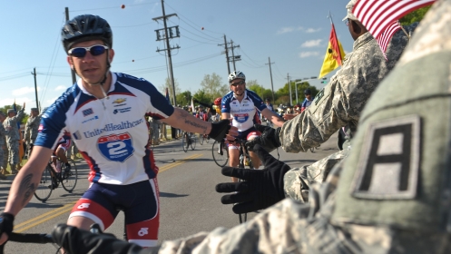 Soldiers, civilians, and family members from Division West, First Army, cheer Healing Heroes and other cyclists during the annual Texas Challenge event of the Ride to Recovery at Fort Hood, TX Apr 11.