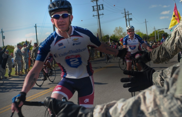 Soldiers, civilians and Family members from Division West, First Army, cheer Healing Heroes and other cyclists during the annual Texas Challenge event of the Ride to Recovery at Fort Hood, TX Apr 11.