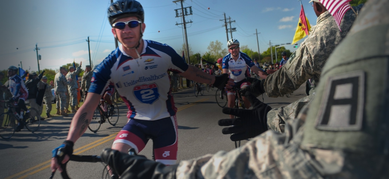 Soldiers, civilians and Family members from Division West, First Army, cheer Healing Heroes and other cyclists during the annual Texas Challenge event of the Ride to Recovery at Fort Hood, TX Apr 11.