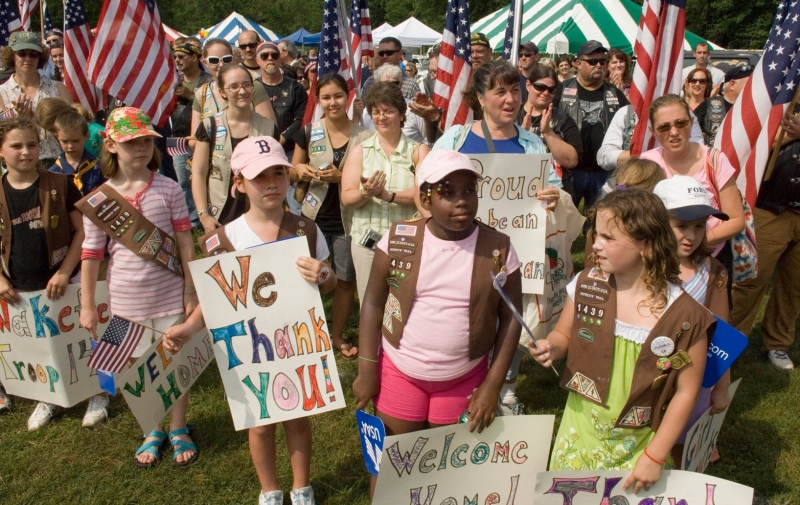 Girl Scouts from across eastern Massachusetts welcome home more than 50 base Airmen June 27 at Hanscom Air Force Base, Mass. The gathering was part of a Heroes' Homecoming celebration. Earlier this year, hundreds of Girl Scouts came to Hanscom AFB to deliver more than 10,000 boxes of Girl Scout cookies that were sent to deployed military members around the world, photo by Rick Berry/U.S. Air Force 