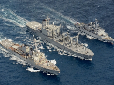 The Arleigh Burke-class guided-missile destroyer USS Curtis Wilbur (DDG 54, left) conducts a replenishment-at-sea with the Japan Maritime Self-Defense Force Towada-class replenishment ship JS Hamana (AOE 424, center) and French Floreal-class light frigate FNS Prairial (F731, right)