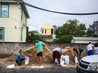 Claire Byun, left, and Olin Parker, prepare sandbags for distribution at the Mid-City Library as Hurricane Delta approaches in New Orleans, Louisiana, October 7, 2020, photo by Kathleen Flynn/Reuters
