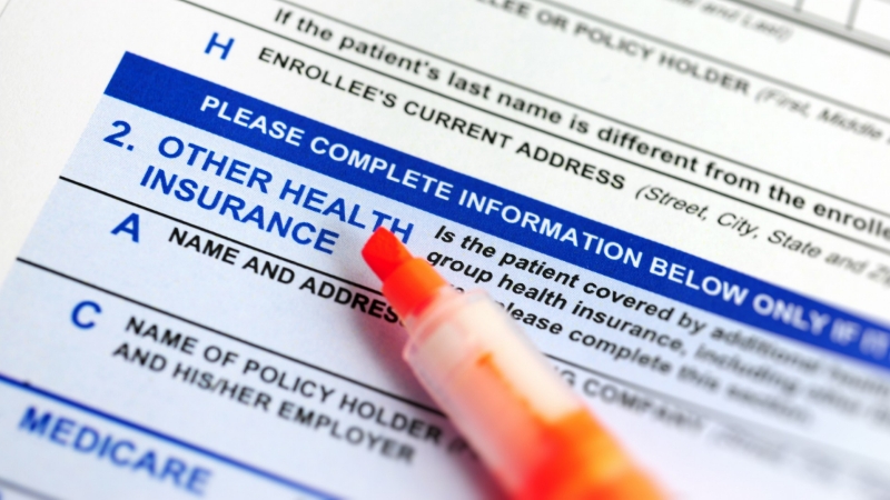 Close up of health insurance form with highlighter, photo by teekid/Getty Images