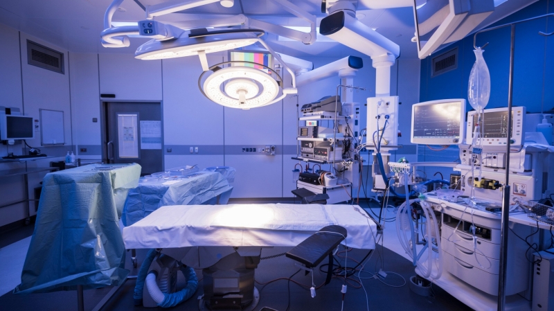 Empty hospital operating room with light on above the operating table, photo by JohnnyGreig/Getty Images