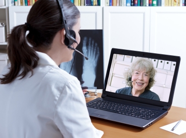 Woman talks to doctor using telemedicine