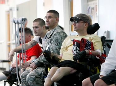Service members involved in physical therapy at Brooke Army Medical Center in San Antonio wait for President Bush to visit