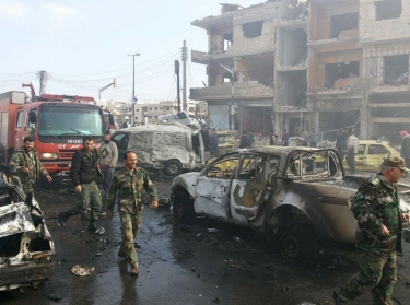 Syrian army soldiers inspect the site of a two bomb blasts in the government-controlled city of Homs, Syria, on February 21, 2016