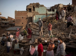 Residents clear debris as they look for their belongings from collapsed houses following Saturday's earthquake in Bhaktapur, Nepal, May 1, 2015