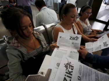 Colombian women listen as a health worker distributes information how to prevent the spread of the Zika virus in Bogota, Colombia January 31, 2016