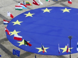 A large European Union flag lies at the centre of Schuman Square outside European Commission headquarters in Brussels, Belgium, May 8, 2021.