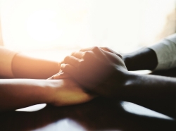 Closeup shot of two people holding hands in comfort.