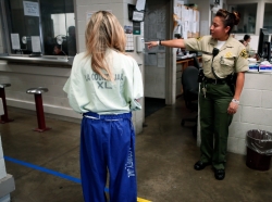 Sheriff's deputies register new arrivals at the Los Angeles County Women's jail in Lynwood