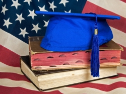 American flag, books, and graduation cap