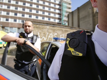 Police constables wearing body-worn video (BWV) cameras, before a trial by the Metropolitan police, at Kentish Town in London, May 6, 2014