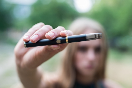 Young woman holding an e-cigarette