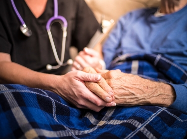 A hospice nurse visiting an elderly patient