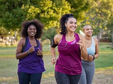 Group of women jogging together at park, photo by Ridofranz/Getty Images