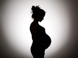 Silhouette of pregnant woman, photo by nelic/Getty Images