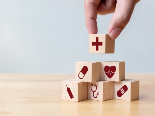 Hand stacking blocks with medical icons