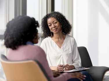 A therapist listens to a patient, photo by SDI Productions/Getty Images