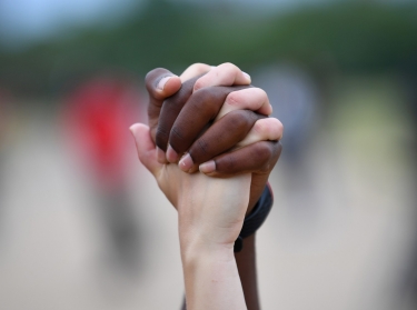 A man and a woman hold hands aloft during a Black Lives Matter protest in Hyde Park, London, June 3, 2020, photo by Dylan Martinez/Reuters
