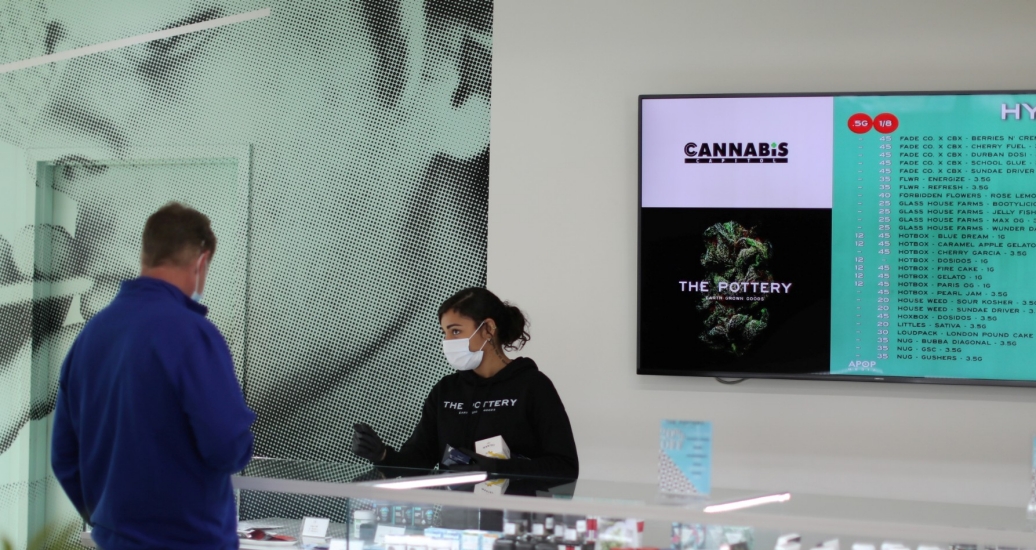 Ashlee Mason, 26, serves a customer at The Pottery Cannabis Dispensary, as marijuana deliveries increase amid the spread of COVID-19, in Los Angeles, California, April 14, 2020, photo  by Lucy Nicholson/Reuters