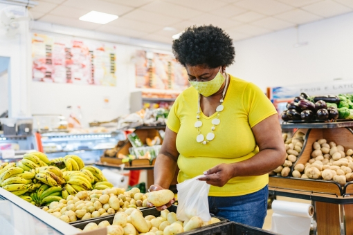 Woman in the grocery store buying produce