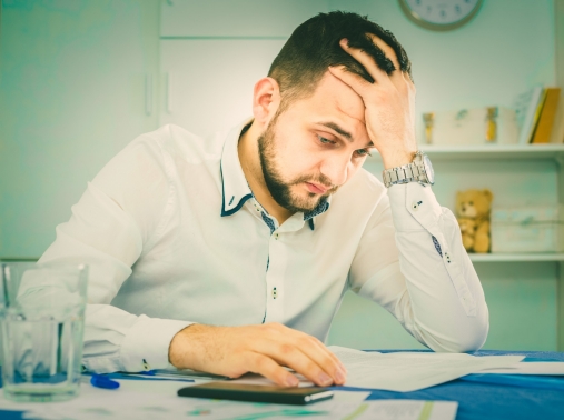 Distressed man having difficulties with paying utility bills and rent