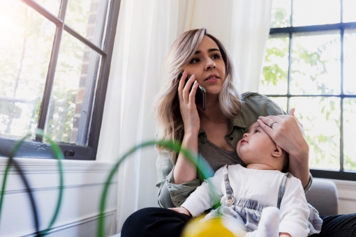 Mother calling doctor about her baby's fever