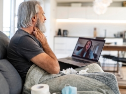 Man talking on telemedicine with doctor, photo by AzmanJaka/Getty Images