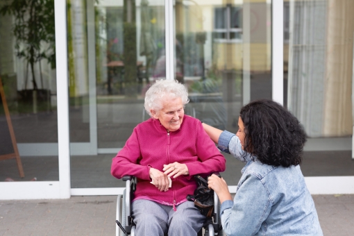 Senior woman in wheelchair with caregiver