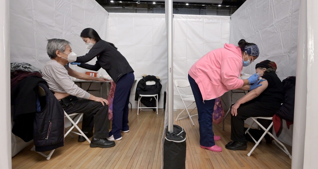 An elderly married couple receive the COVID-19 vaccine at the same time inside the Korean Community Services center in Queens, New York, February 11, 2021