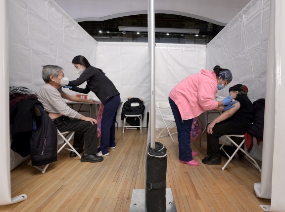 An elderly married couple receive the COVID-19 vaccine at the same time inside the Korean Community Services center in the Queens borough of New York City, New York, February 11, 2021, photo by Anthony Behar/Reuters
