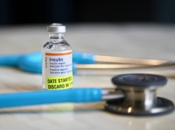 Insulin vial and stethoscope, photo b y Samara Heisz/Getty Images